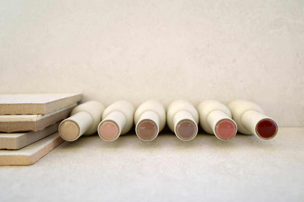 Row of ANGELIQ gel polish bottle with different finishes on a light surface.