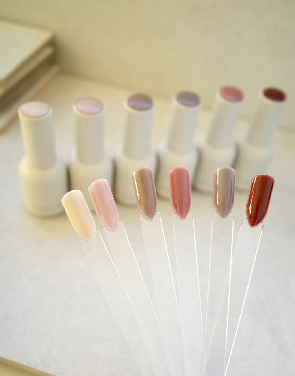 Set of ANGELIQ nail polish bottles with samples on a white background